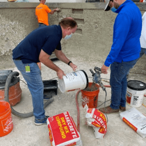 Alpha West reps using Basecrete to waterproof a concrete pool