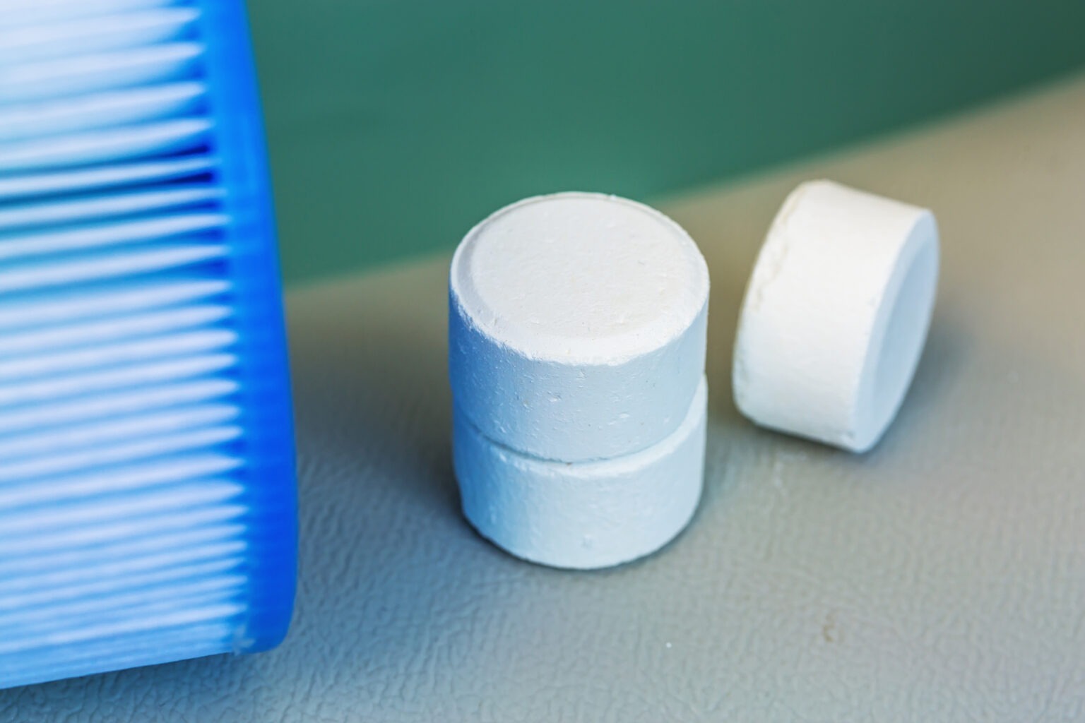 Chlorine tablets next to a pool and filter