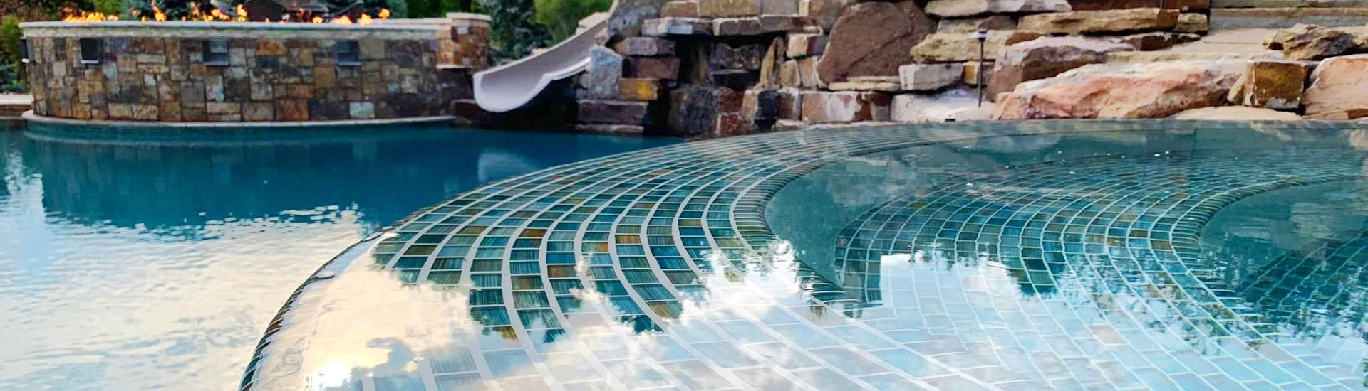 glass tile spa in a pool